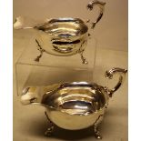 A pair of George II silver sauceboats, with fretwork borders, cast leaf capped scroll handles, one