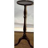 A mid eighteenth century mahogany torchere, the circular dished top, on a slender channelled triform
