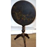 A nineteenth century French black and gold lacquer decorated occasional table, the circular tilt top