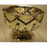 A late Victorian silver rosebowl, with rococo spray repousse sides, with flutes and beading, on a