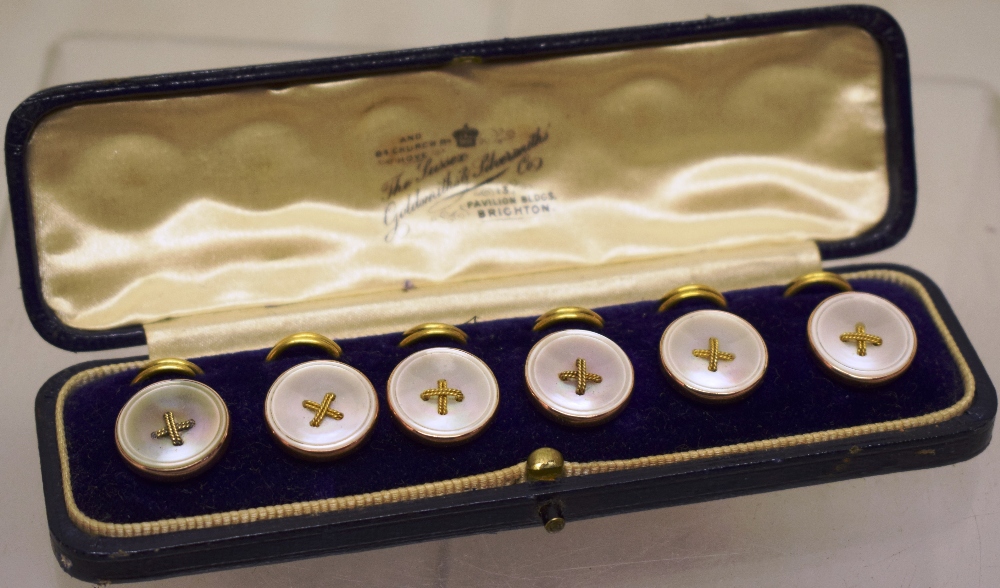 A set of six early nineteenth century 9ct gold and mother of pearl dress buttons, cased.