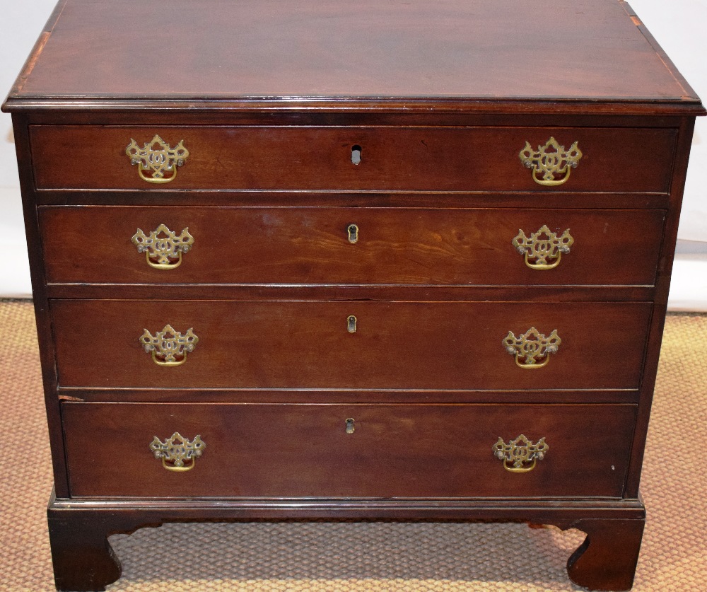 A small early nineteenth century mahogany veneered chest of low proportions, the top inlaid