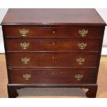 A small early nineteenth century mahogany veneered chest of low proportions, the top inlaid