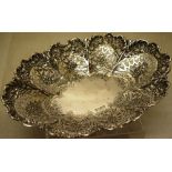 A late Victorian silver navette shape bread dish, the pierced panelled sides with chased and