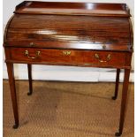 A Sheraton mahogany roll top desk, the top with a gallery above a tambour shutter fall revealing