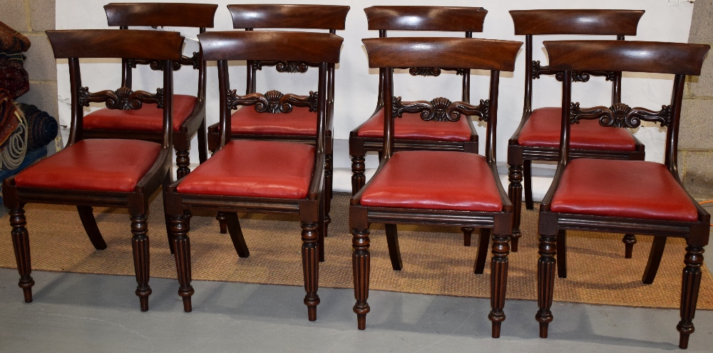 A set of eight William IV mahogany side chairs, with shell scroll carved back rails, the padded