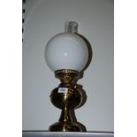 A Brass Oil Lamp with chimney and white shade