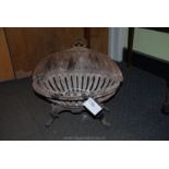 An oval cast iron Fire Basket on four legs