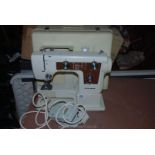 A cased New Home electric Sewing Machine