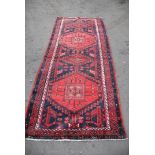 A red and black Turkish style wool Rug with geometric pattern,