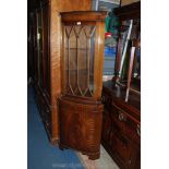 A reproduction Mahogany floor standing two door Georgian style Corner Cabinet with moulded cornice,