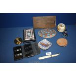 A cased stainless steel knife set and bottle opener, two copper and enamel plaques,