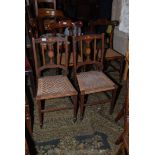 A pair of Edwardian inlaid Bedroom Chairs having inlaid top rail and splat, rattan seats,