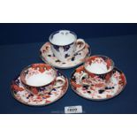 Three Royal Crown Derby cups and saucers, one cup damaged and one set faded.