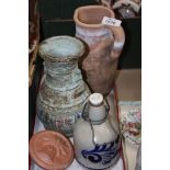 An earthenware jug, Goebel stoneware bottle, ethnic pot and two terracotta Plaques.
