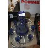 A Bristol blue coloured glass Decanter on white metal stand with six matching glasses