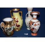 Four various vases to include a twin handled yellow jug with gilt and blue rim having foliage