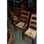 A set of six contemporary Oak ladder back Dining Chairs (including two carvers) having three bar