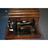 A Frister & Rossmann hand Sewing Machine with case and instructions