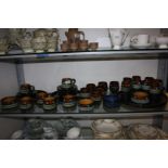 A quantity of Celtic Newlyn pottery including one large circular tray, nine saucers, coffee cups,