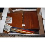 Two wooden Artist's boxes with paints, a quantity of paint brushes, oil pastel crayons, etc.