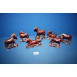 Seven oriental wooden figures of Horses, in various poses.