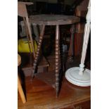 A 1920's Oak octagonal top Occasional Table with carved top on three bobbin style turned legs with