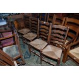 A set of four reproduction Clisset style Dining Chairs having ladder backs with five shaped bars,