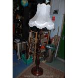 A Bulbously turned Victorian style mahogany Standard Lamp and silk tasselled Shade