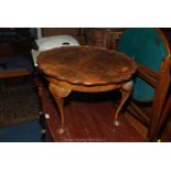 A 1950's Walnut occasional Table having wavy edge, burr top,