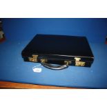 A bridle leather Attaché Case in black with green skiver lining and brass fittings,