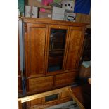 An Edwardian Walnut two door Wardrobe with central full length mirror, corbel detail,