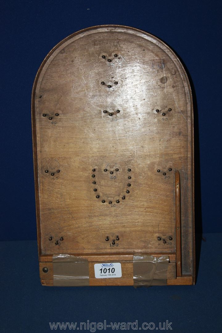 A small wooden Bagatelle board,