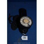A rare and collectable black painted metal and brass cased single piece dial Telephone issued by