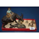 Four miniature Chinese figures and two Water Buffalo figures,