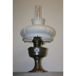 A paraffin Lamp with chimney and white shade