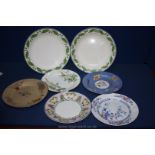 Seven Wedgwood plates of various sizes and decoration including flowers and butterflies,