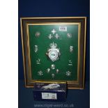 A framed collection of Police badges and a boxed model Jaguar.
