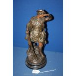 A cast metal kilted Scottish Ghillie Figure,