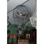 A metal openwork four branch chandelier in the form of a hot air balloon