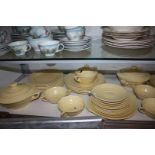 A good quantity of Wedgwood 'Matt Straw' dinnerware designed by Keith Murray