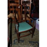 An Edwardian Mahogany boxwood strung Elbow Chair with splat and slat back,