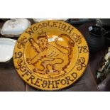 A large slip ware Charger having script 'Woodleigh Freshford 1978'