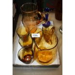 An amber glass lemonade Jug and five Glasses plus one other Jug together with a blue glass footed