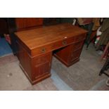 An Edwardian mahogany Kneehole Desk with plain rectangular top over three frieze drawers,