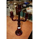 A Victorian red moulded glass three branch Candlestick