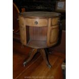 A reproduction Mahogany leather topped Drum Table with three frieze drawers and three false drawer