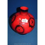 A ruby fusion Vase by Peggy Davis in globular form with poppy design