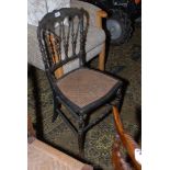 A late Victorian Ebonised Bedroom Chair with gold painted decoration, delicate spindles to the back,