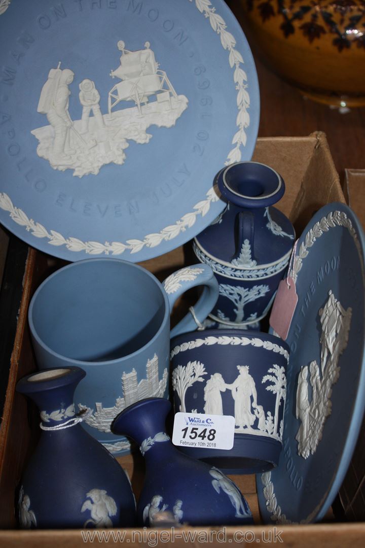 A quantity of blue and white Wedgwood china to include man on the moon plates, various vases,